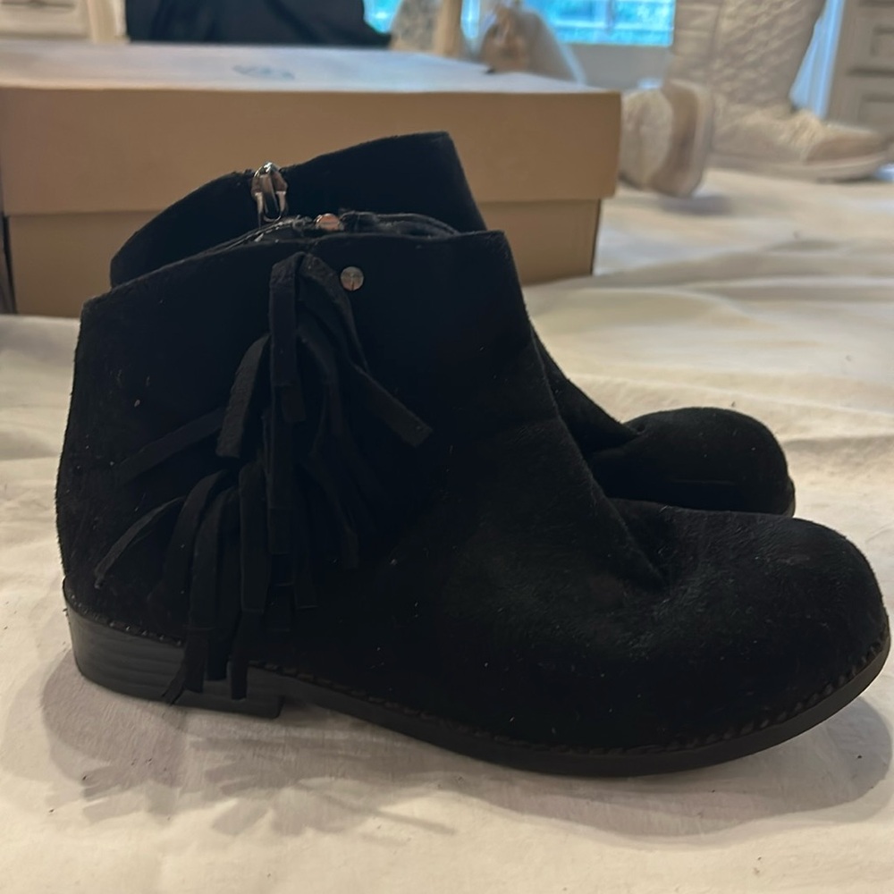 It’s suede black booties with fringe